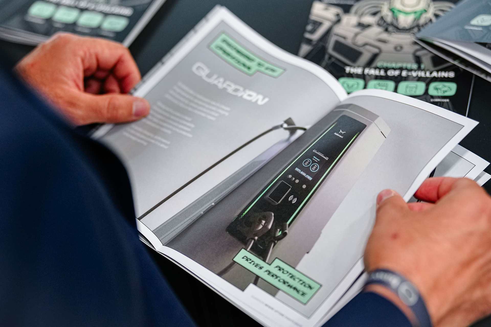 Visitor reading the GUARDiON comic book: Protection Drives Performance