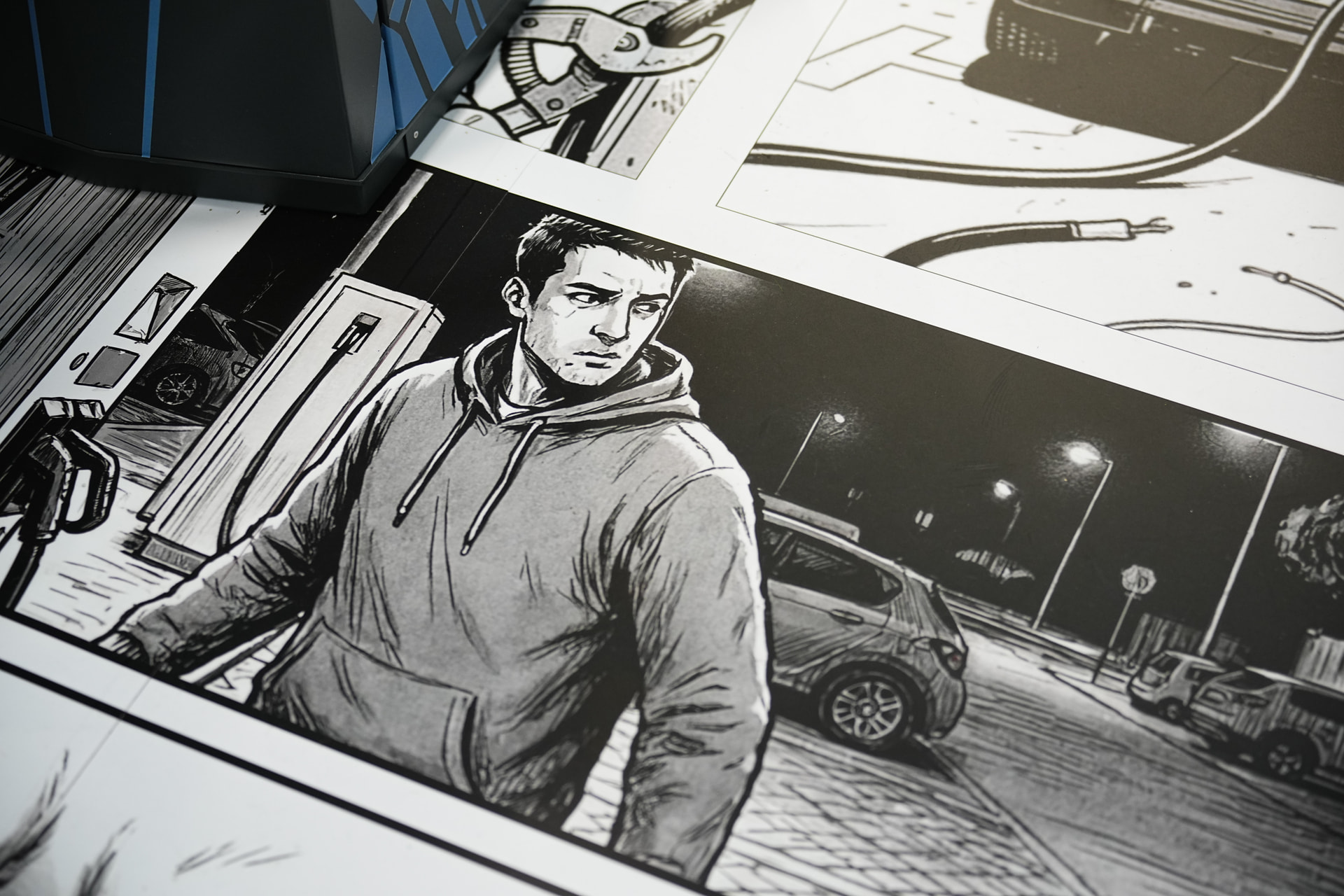 Comic-book floor graphics at the booth: the villain approaches a charging station at night