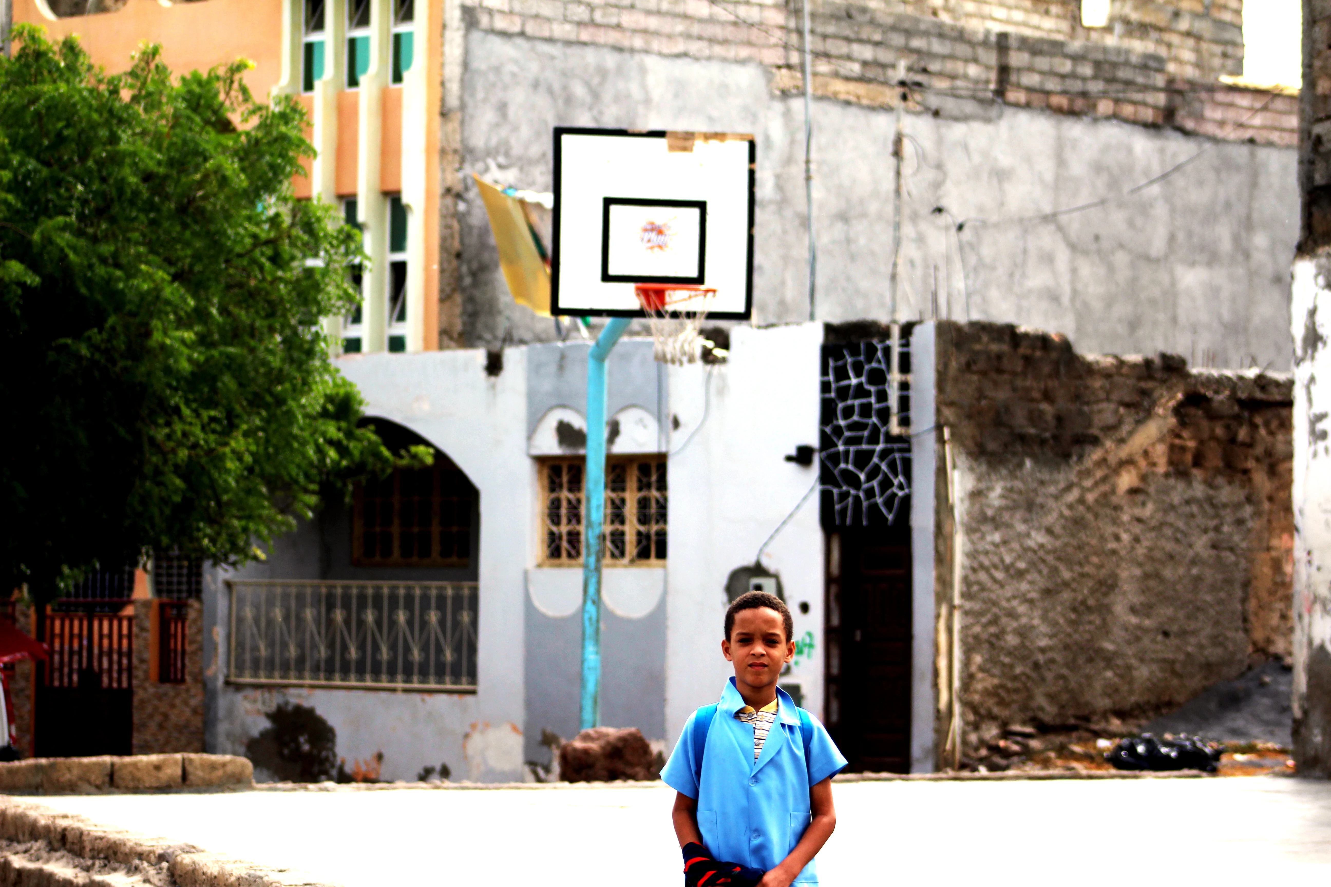 Kid playing basketball on the street